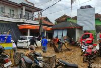 1761650112022-warga-kampung-tugu-saling-membantu-mengevakuasi-motor-dan-perabot-rumah-tangga-yang-rusak-akibat-terendam-lumpur-banyak-warga--1761628876812_169